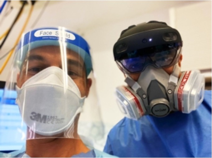 Clinicians in full PPE using HoloLens 2 during a Covid-19 patient consultation, enabling remote multi-disciplinary collaboration through VeriLens and Microsoft Teams